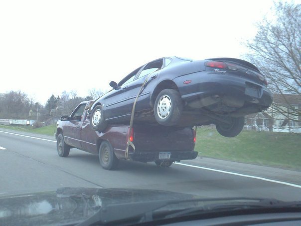 Chevy truck with Taurus in bed